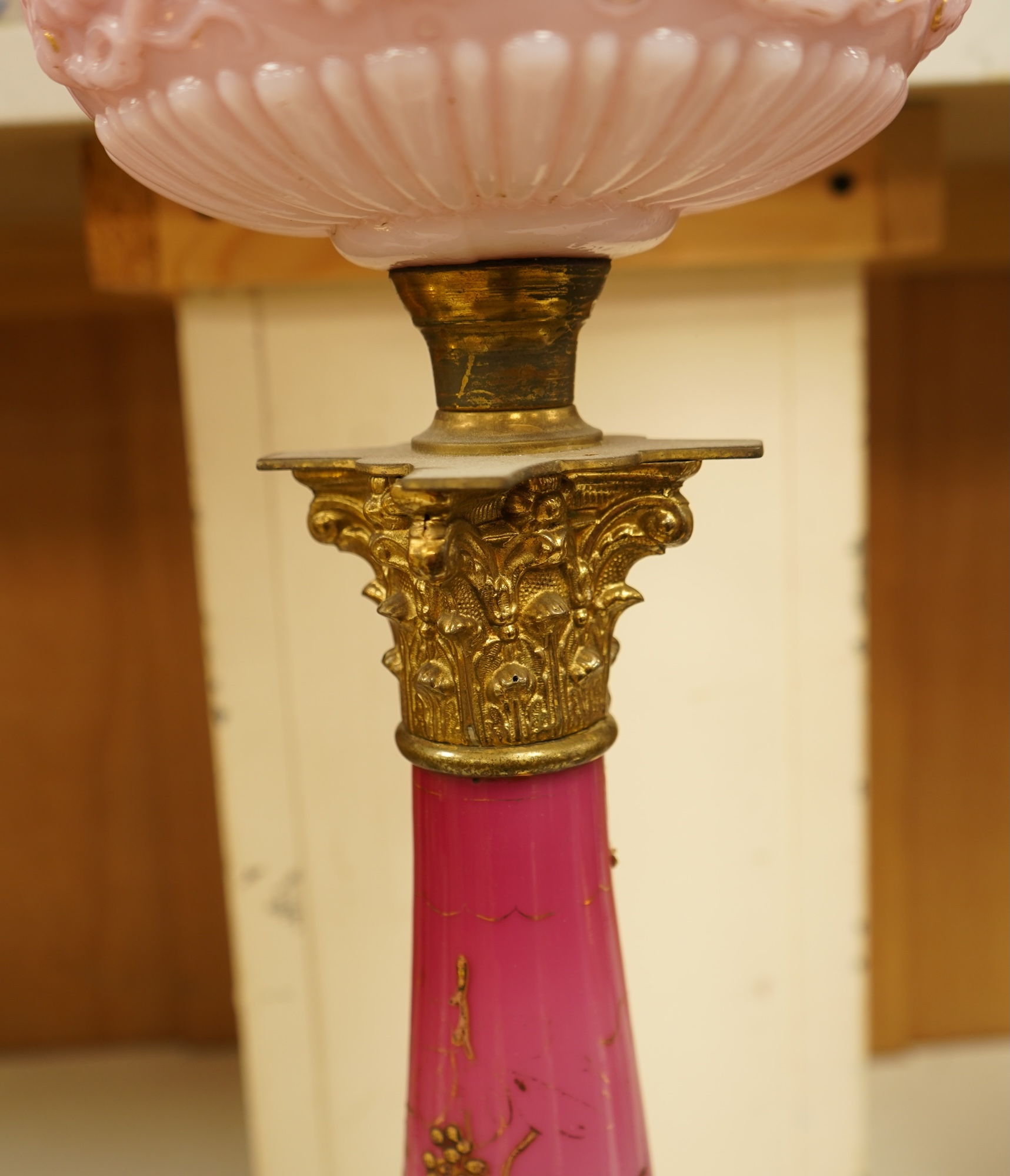 A Victorian brass and ruby glass oil lamp, 80cm high overall